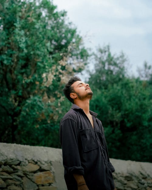 Free Brunette Man Standing with Eyes Closed in Shirt Stock Photo