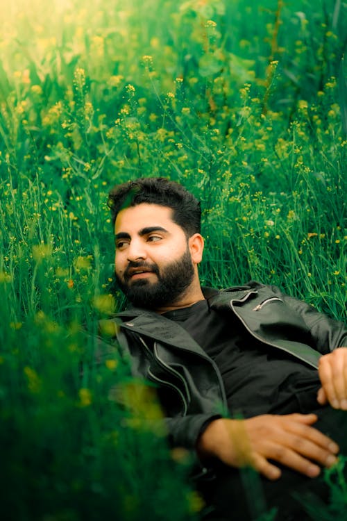 Free Man Lying Among Flowers on a Meadow  Stock Photo