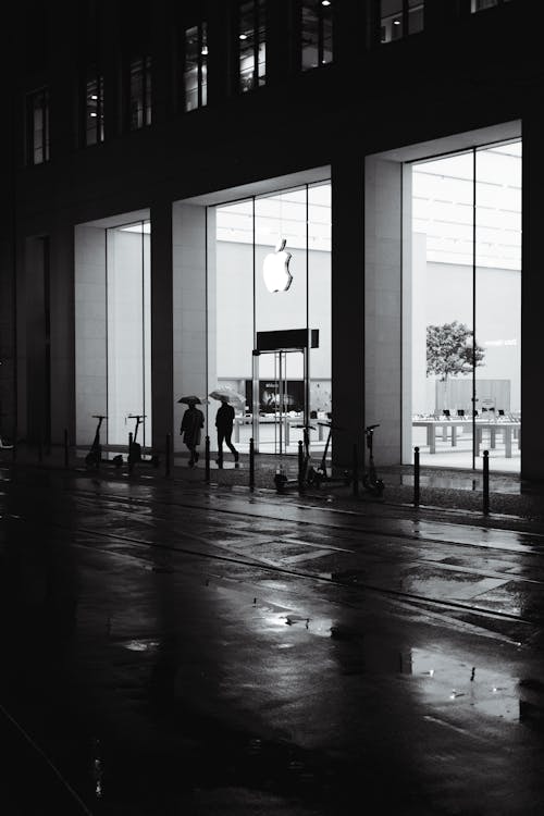 Black and white photo of people walking in the rain