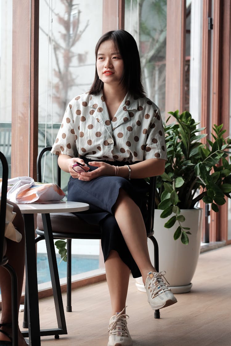 Woman Sitting At Cafe