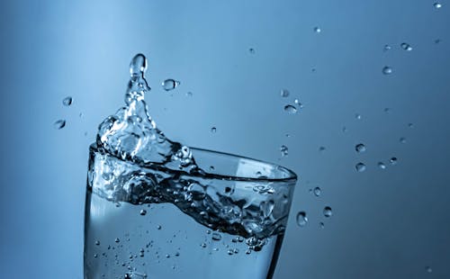 Free A glass of water with a splash of water Stock Photo