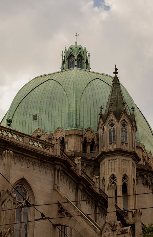 A clock tower with a green dome on top