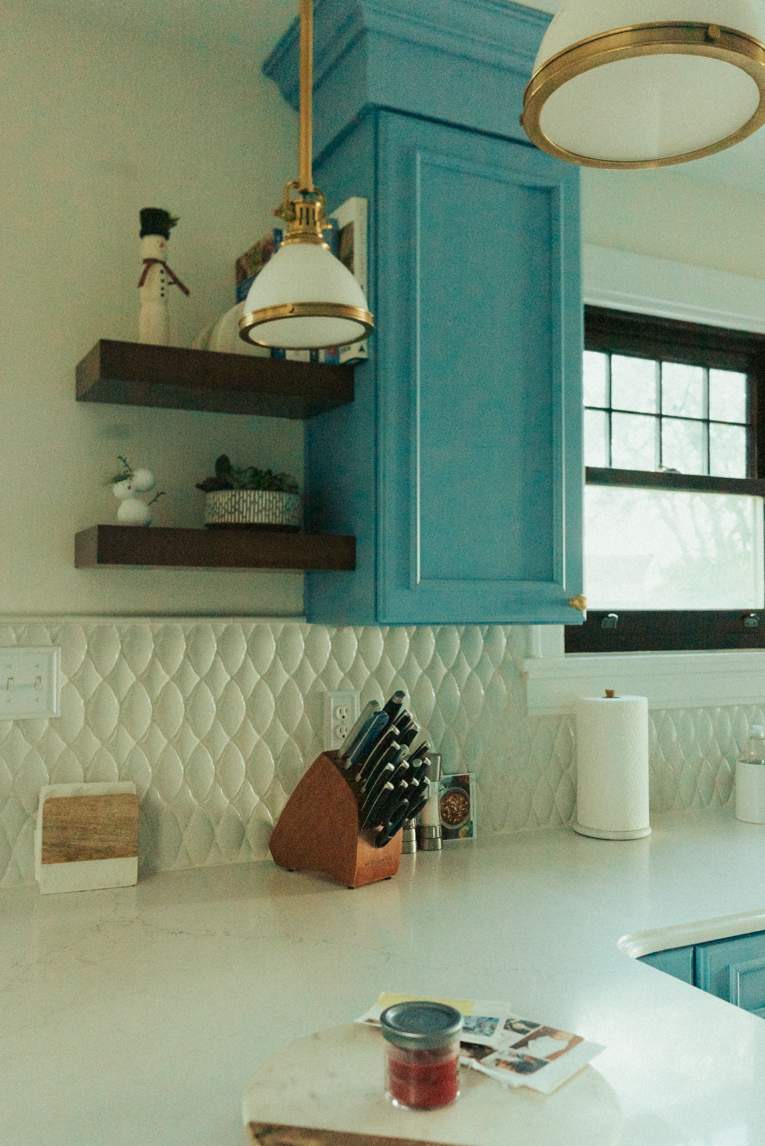 Blue room lit by pendants, daylight and practical task lighting