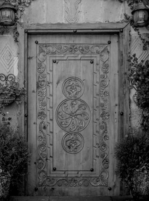 A black and white photo of a wooden door