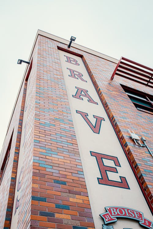 A brick building with a sign that says brave