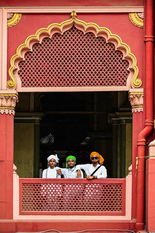Free Three men in turban sitting on the balcony of a building Stock Photo
