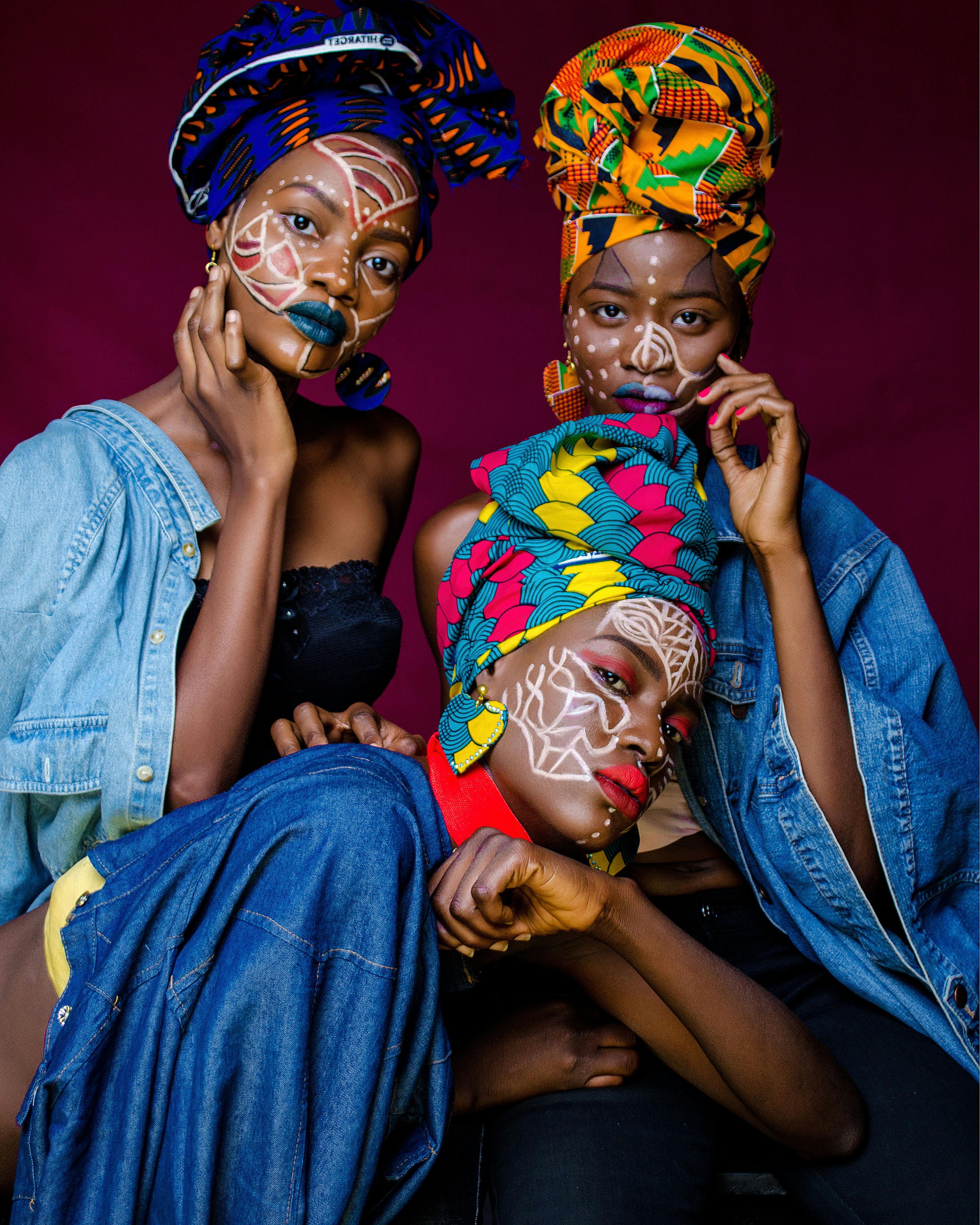 three woman with face paintings