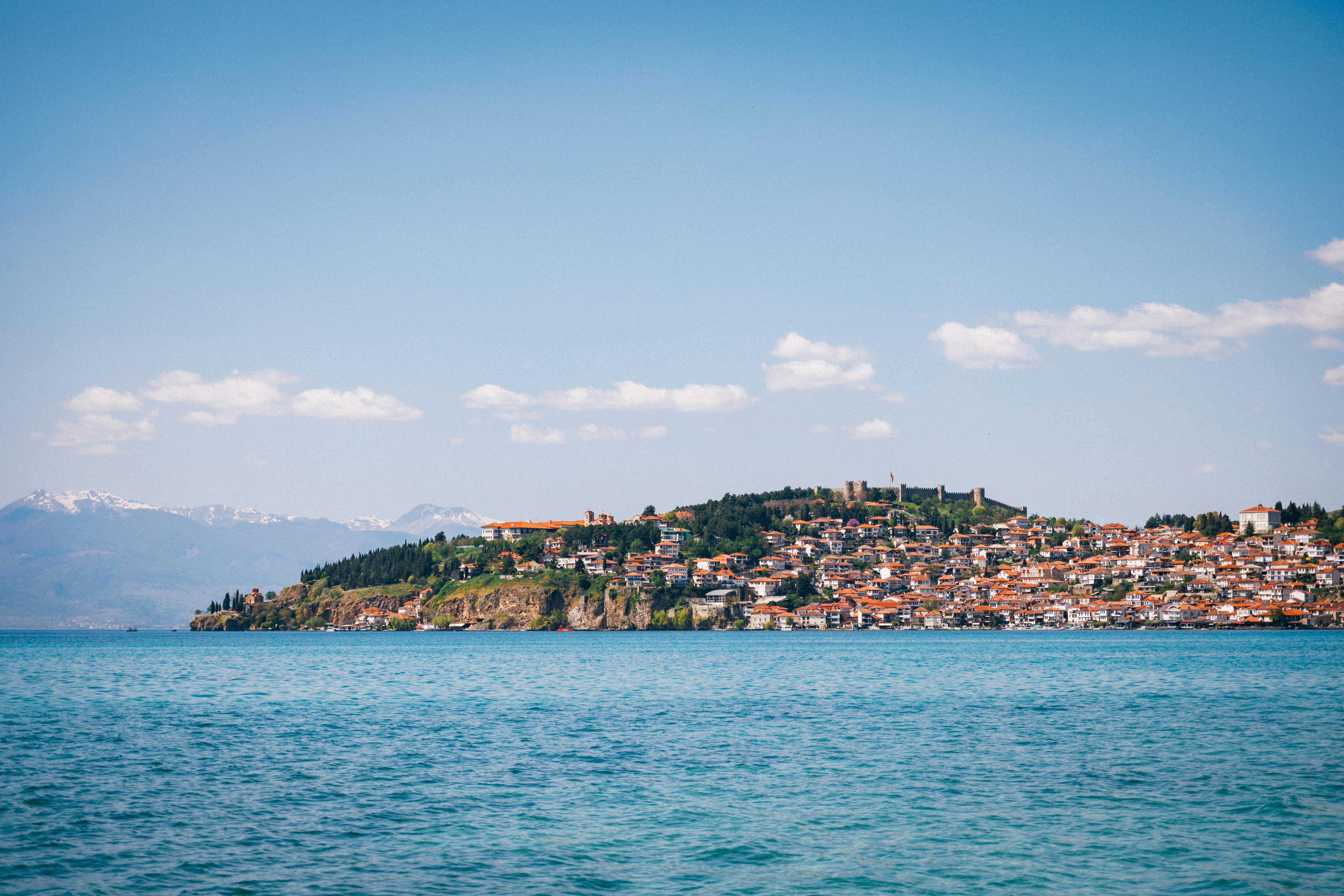 Beautiful panoramic view of Ohrid city along the picturesque Lake Ohrid under a bright blue sky. - Albania