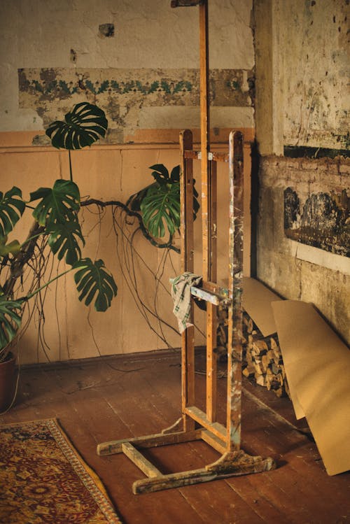 An old wooden easel with a plant on it