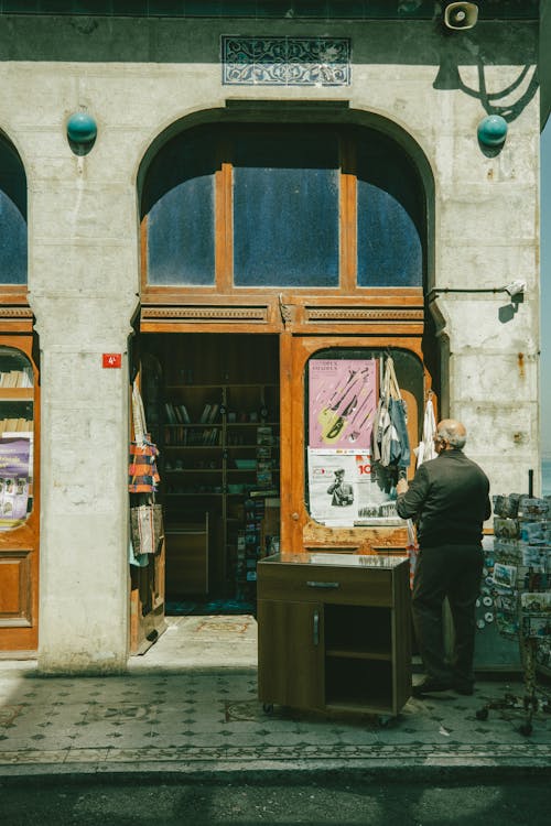 A man standing in front of a book store