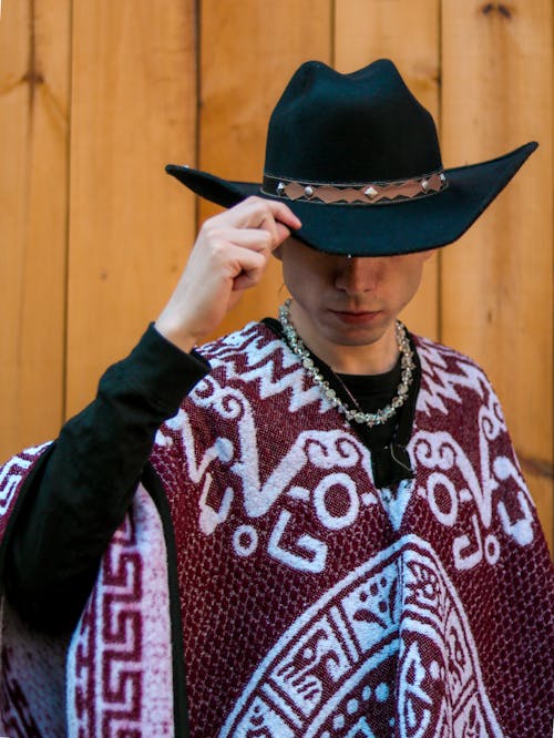 A man in a cowboy hat and poncho