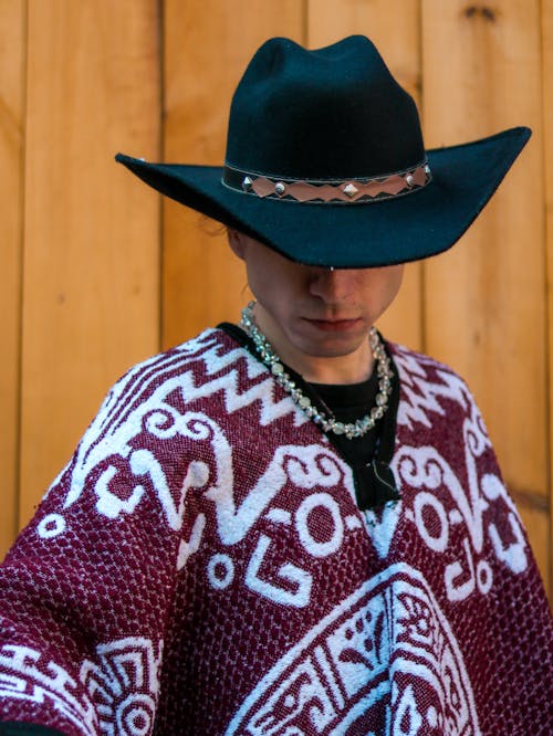 Free A man in a cowboy hat and poncho Stock Photo