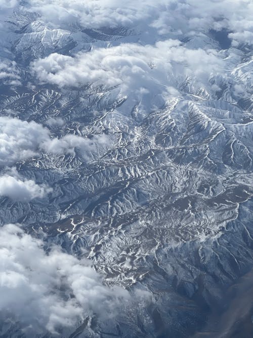 An aerial view of snow covered mountains