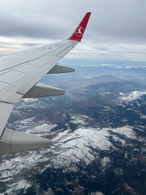 Free Scenic aerial view from an airplane, capturing snow-covered hills and vast landscapes. Stock Photo