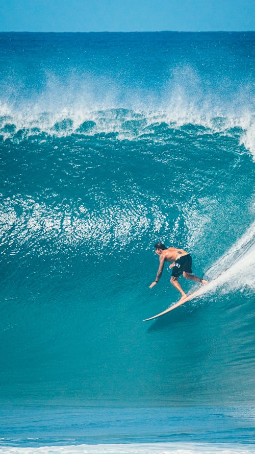 A man riding a wave on a surfboard