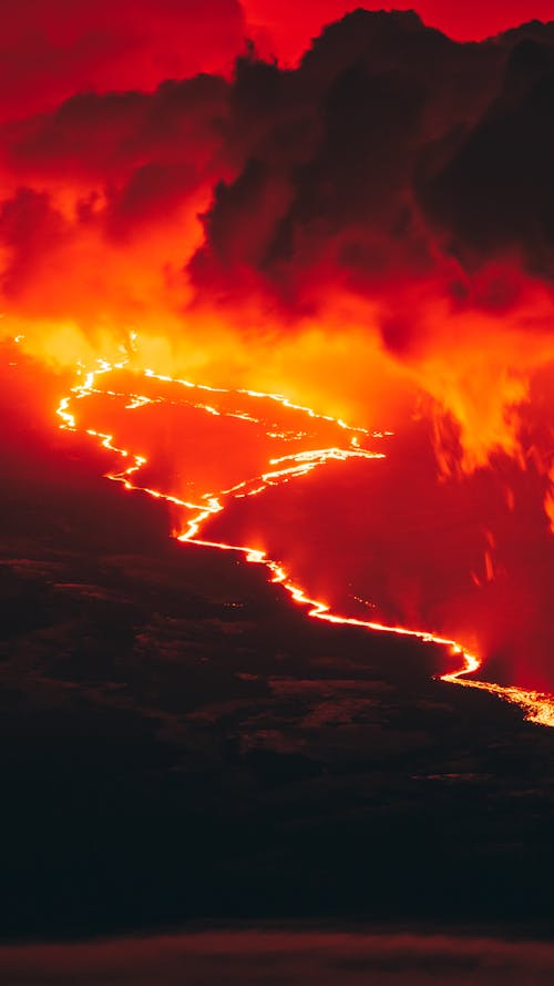 A red and orange sky with a volcano in the background