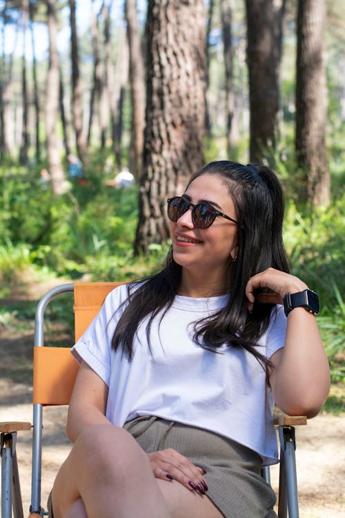 A woman sitting in a chair in the woods