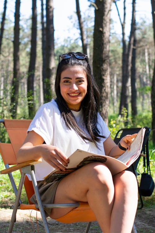 A woman sitting in a chair in the woods