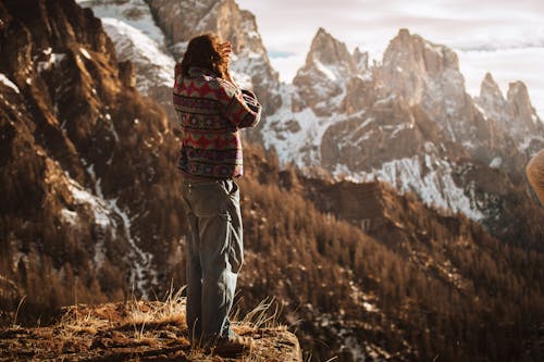Man Standing on Edge in Mountains