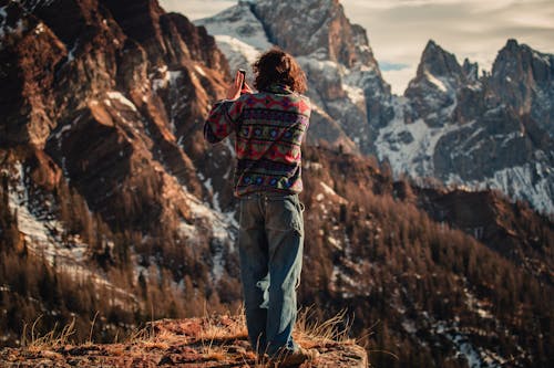 Man Taking Pictures in Mountains