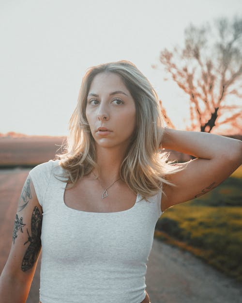 Free A woman with tattoos standing in the middle of a road Stock Photo