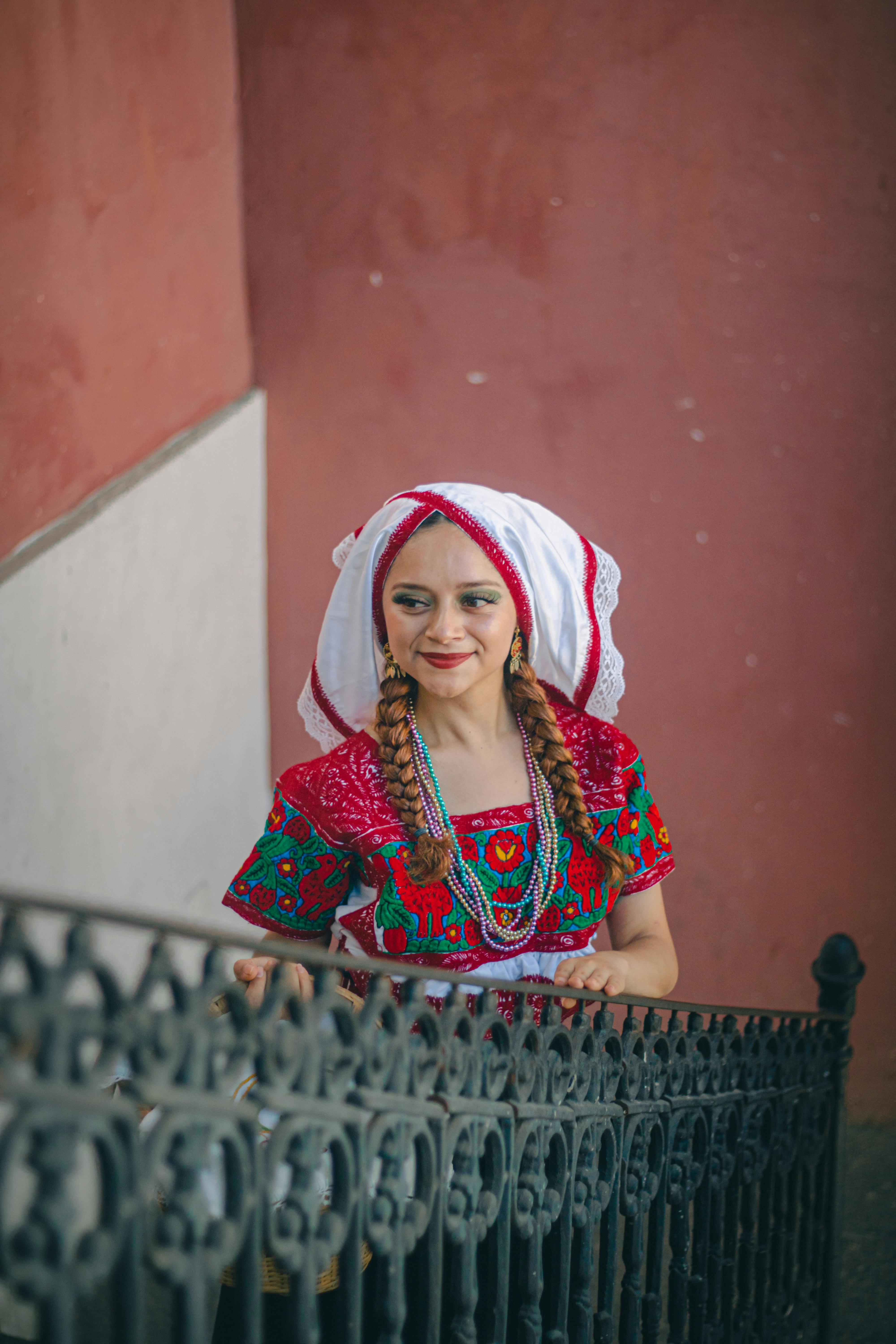 young woman in traditional clothing standing on a staircase