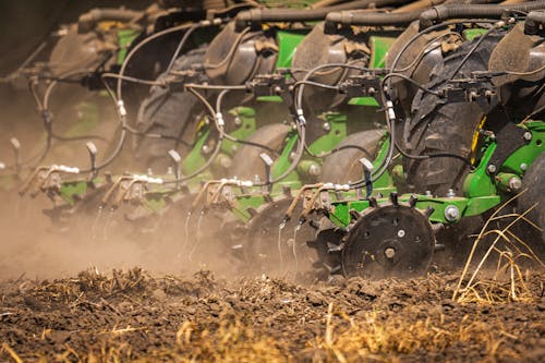 Close-up of a Seeder Sowing Seeds on a Cropland 