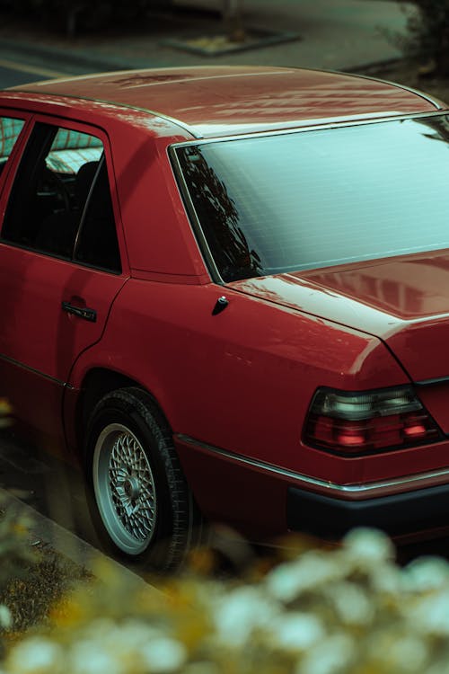 A red car parked on the side of the road