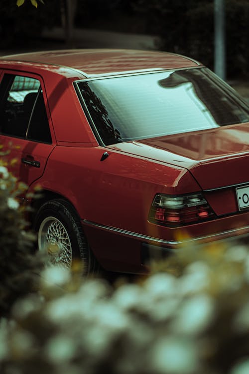 A red car parked in the middle of a street