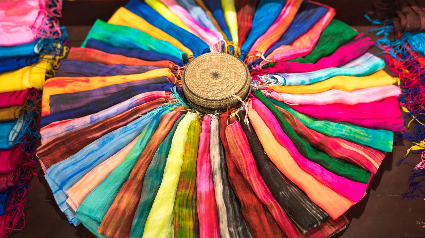 A stunning array of colorful scarves arranged in a circle, showcasing vibrance and creativity.
