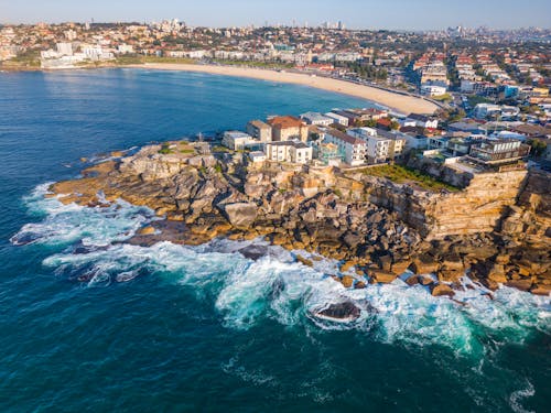 Free Aerial View of City on Rocky Coastline Stock Photo