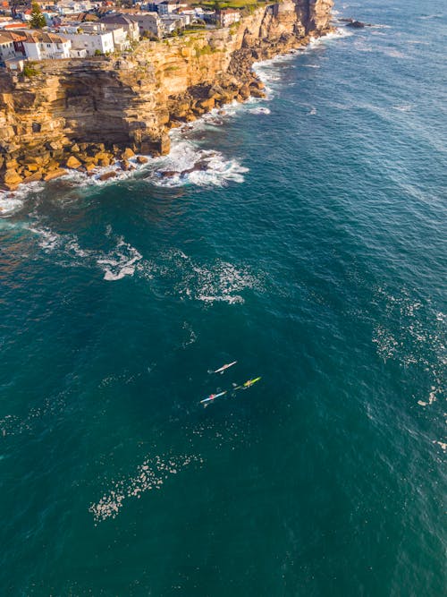 Aerial view of the ocean and cliffs near a city