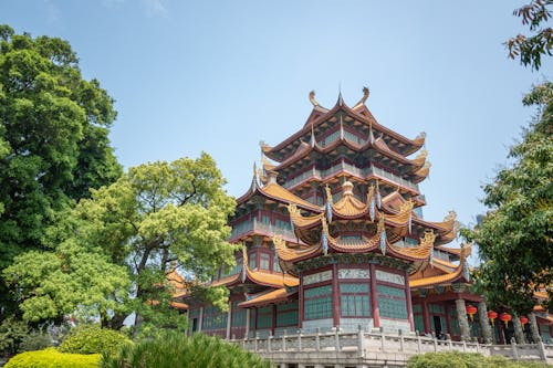 A chinese style building with a green roof