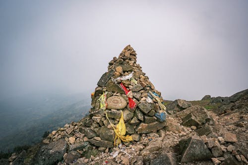 A pile of rocks with a flag on top