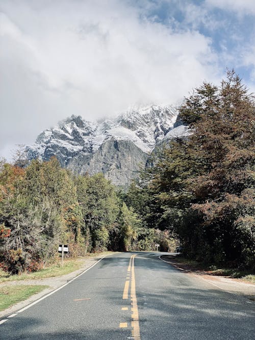 Free Highway and Snowcapped Mountains in the Distance  Stock Photo