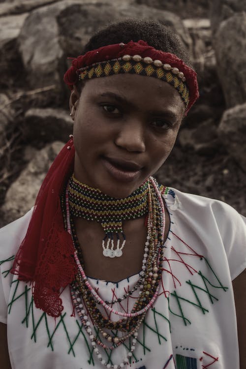 A woman in traditional clothing with a necklace and headdress
