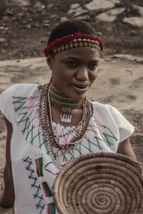 A woman in traditional clothing holding a basket