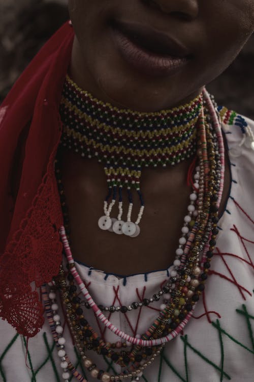 A woman wearing a necklace and necklace with beads