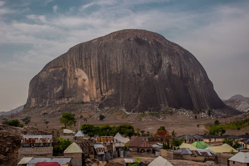 A large rock in the middle of a village