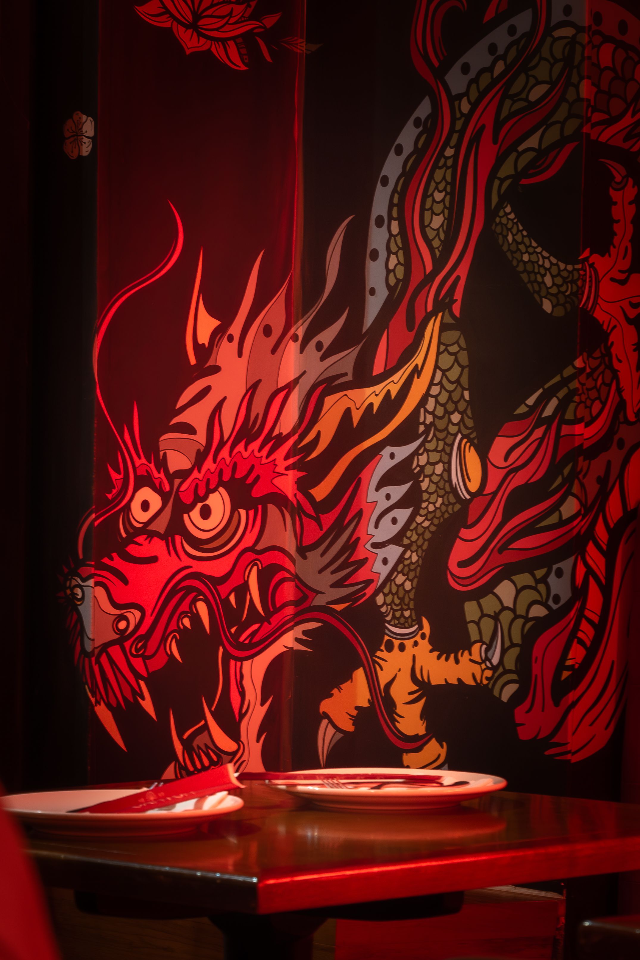 Colorful dragon illustration in a cozy Rio de Janeiro restaurant setting.