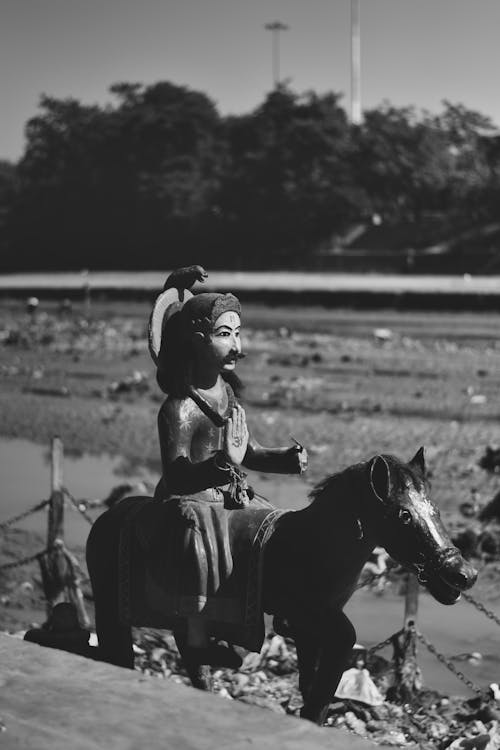 A black and white photo of a man on a horse