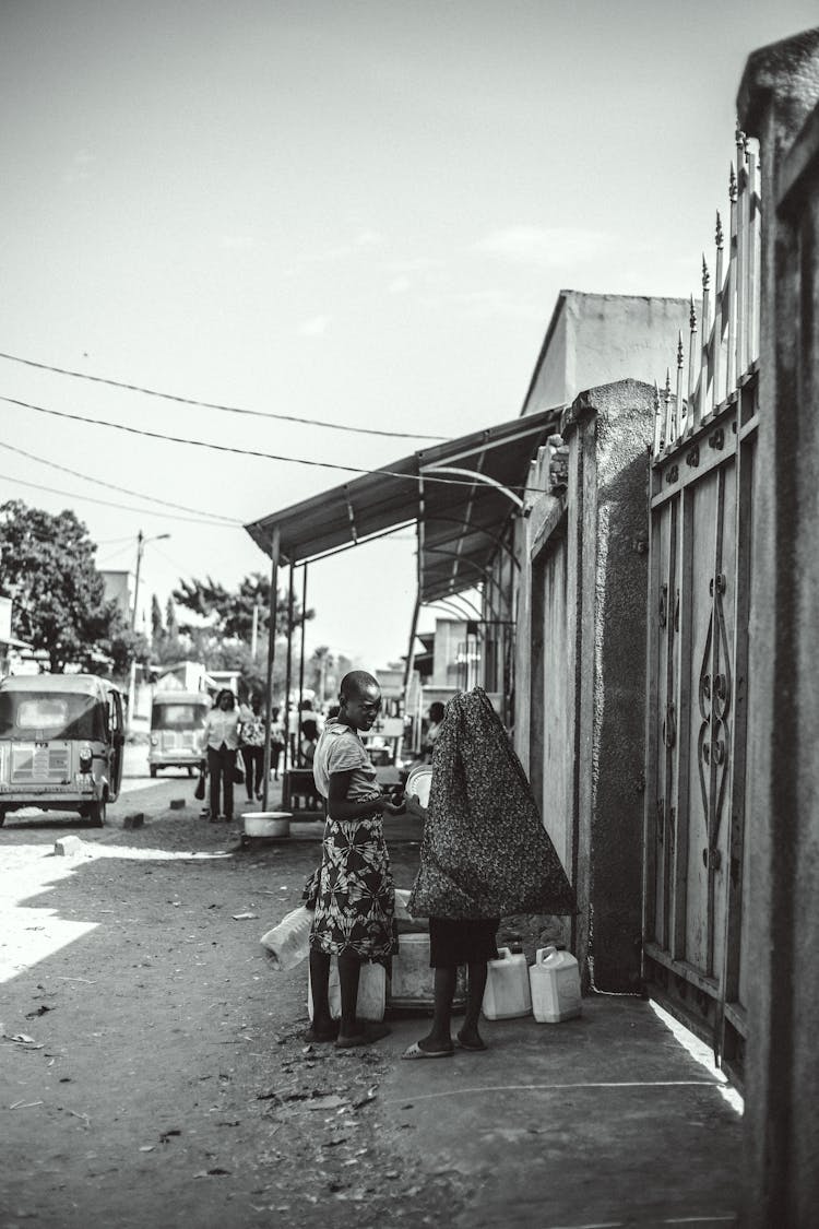 People Standing On Street In Village