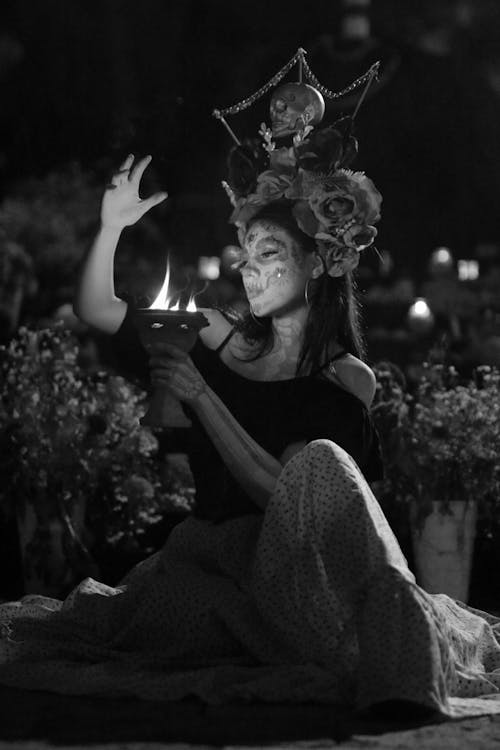 Free A Woman Sitting Outdoors at Night Stock Photo