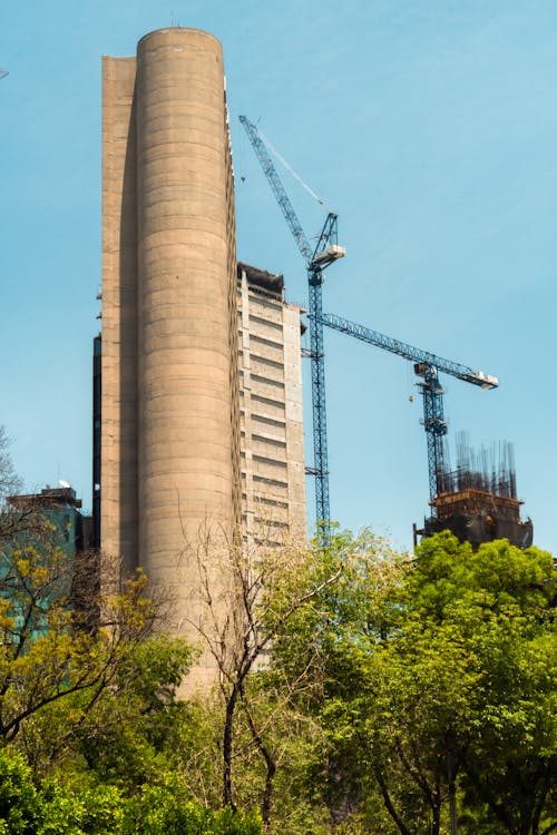 A tall building with a crane in the background