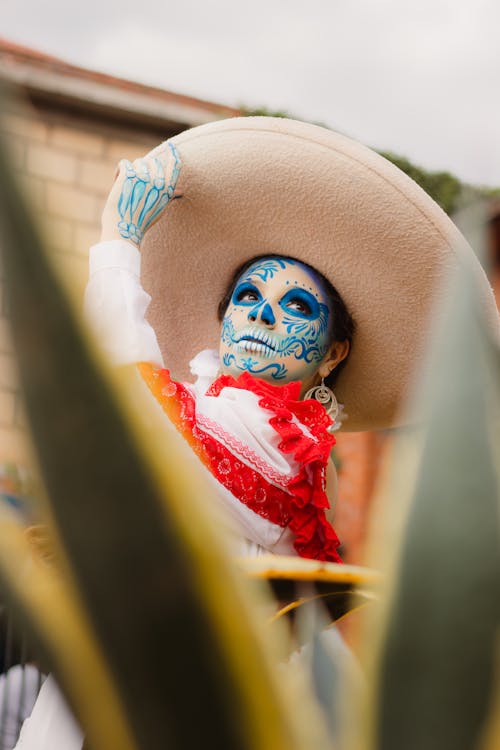 Free A woman with a mexican hat and blue face paint Stock Photo