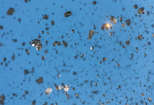 A close up of a blue sky with lots of small particles
