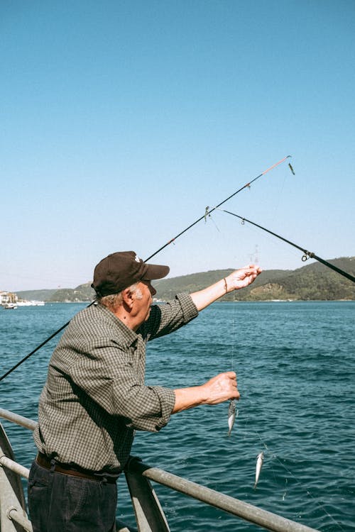 adam, Balık tutmak, deniz içeren Ücretsiz stok fotoğraf