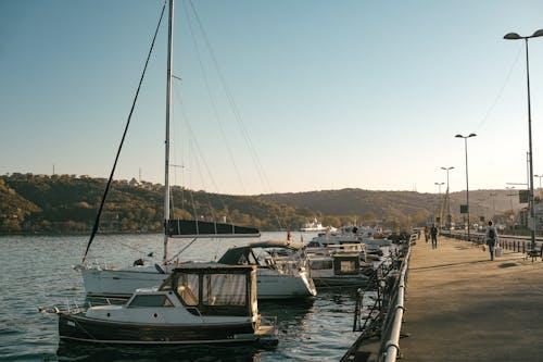 A boat docked at a pier with a view of the water