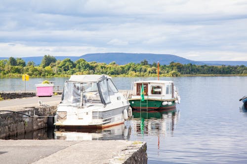 A boat is docked at a dock with a mountain in the background