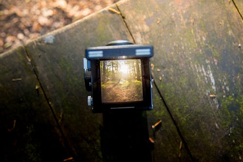 Black Camera on Brown Wooden Table